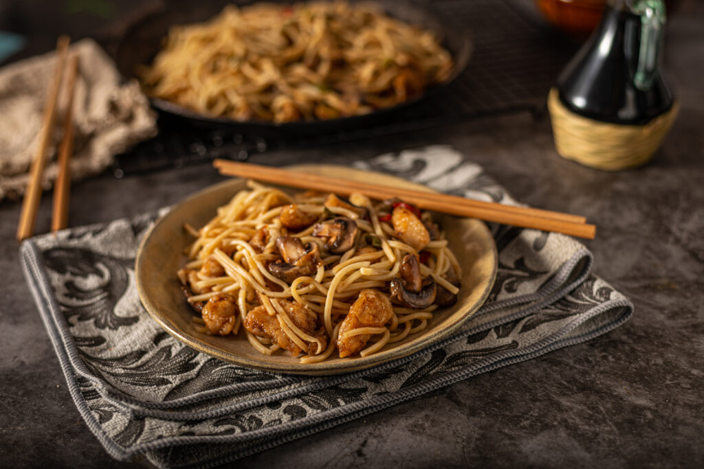 Delicious noodles with crispy chicken and mushrooms